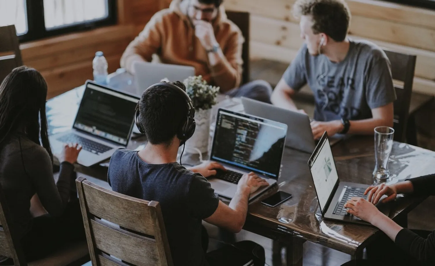 Team working on laptops at a modern office table